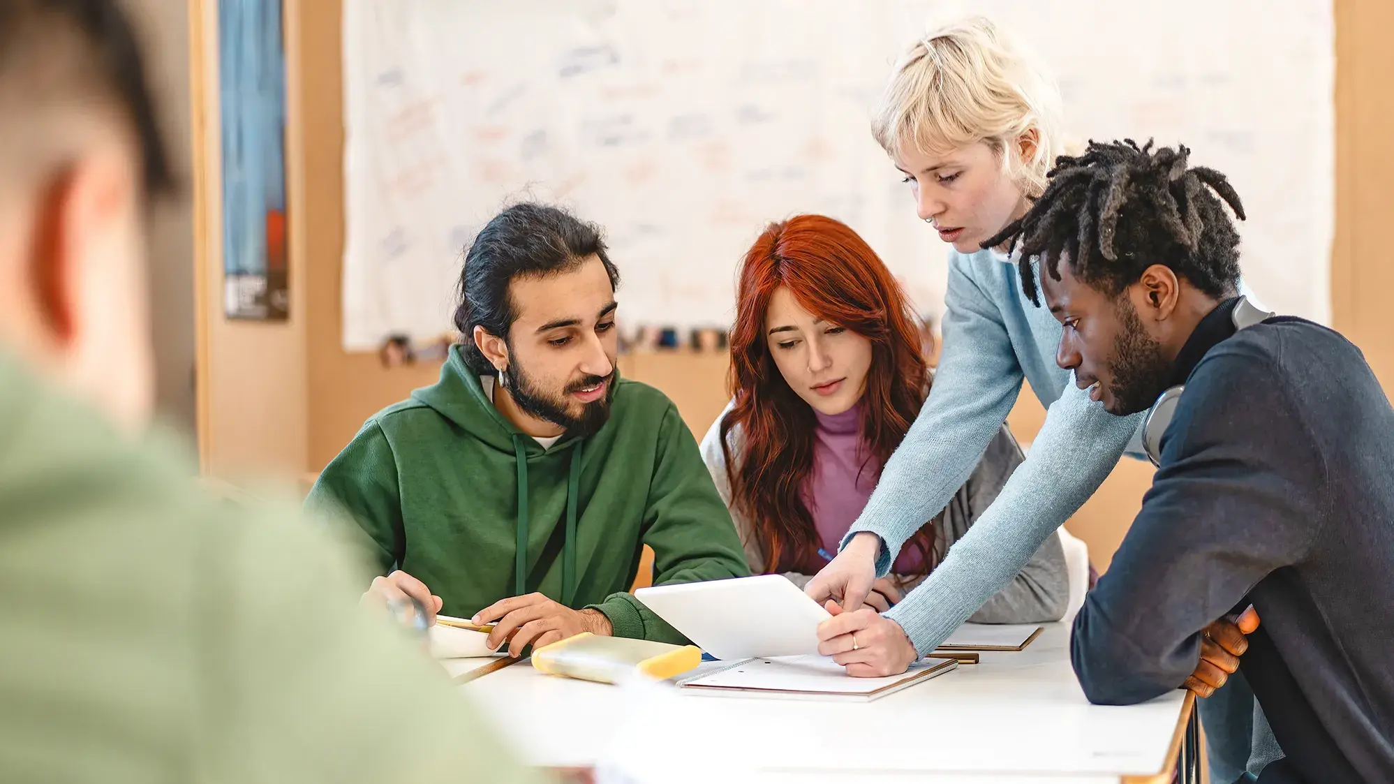 college students evaluating documents at a table