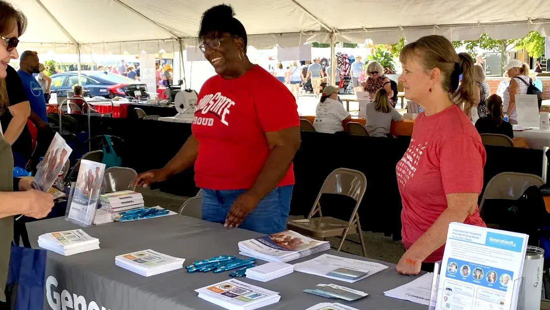two generation rx ambassadors hand out custom materials at a community event