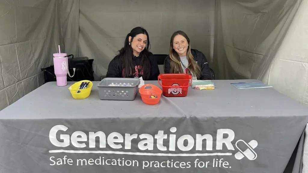 Two students volunteering at Generation Rx table at COSI Big Science Celebration